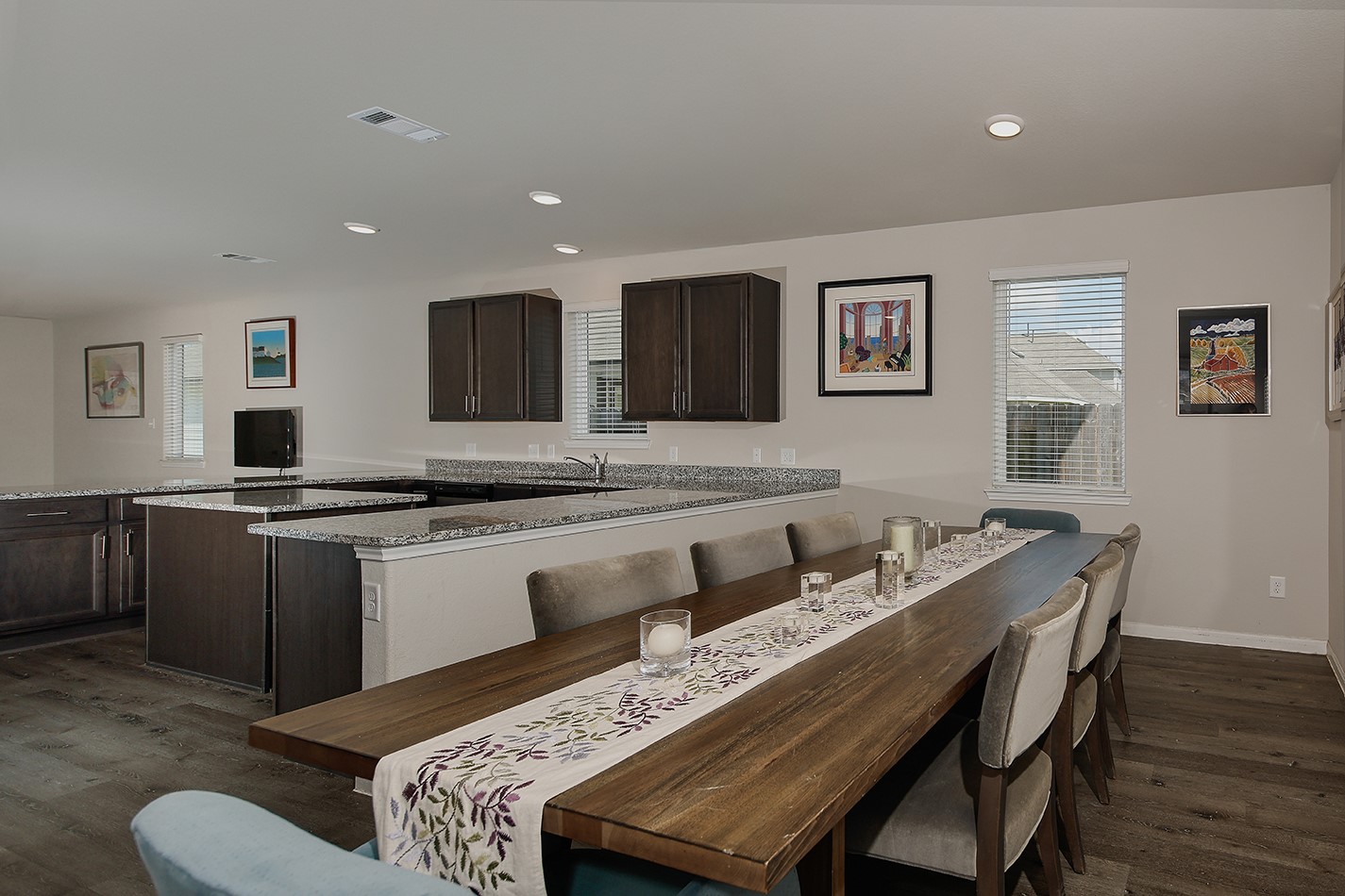 14022 Chinook Drive Conroe, TX 77384 - Photo 12 of 25 a living room with stainless steel appliances kitchen island granite countertop furniture and wooden floor