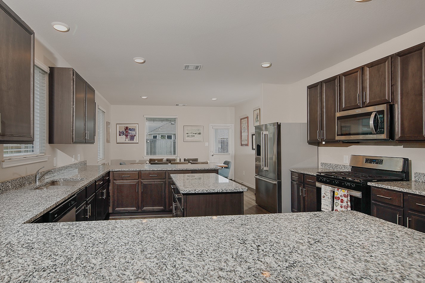 14022 Chinook Drive Conroe, TX 77384 - Photo 8 of 25 a kitchen with stainless steel appliances granite countertop a sink stove and refrigerator