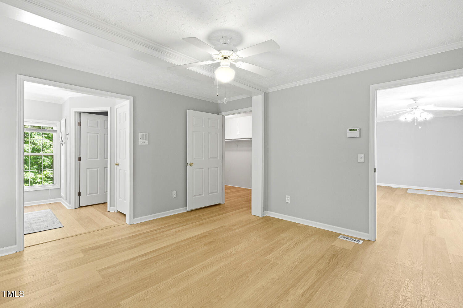134 Rollins Mill Road Holly Springs, NC 27540 - Photo 13 of 33 a view of a room with wooden floor and a ceiling fan