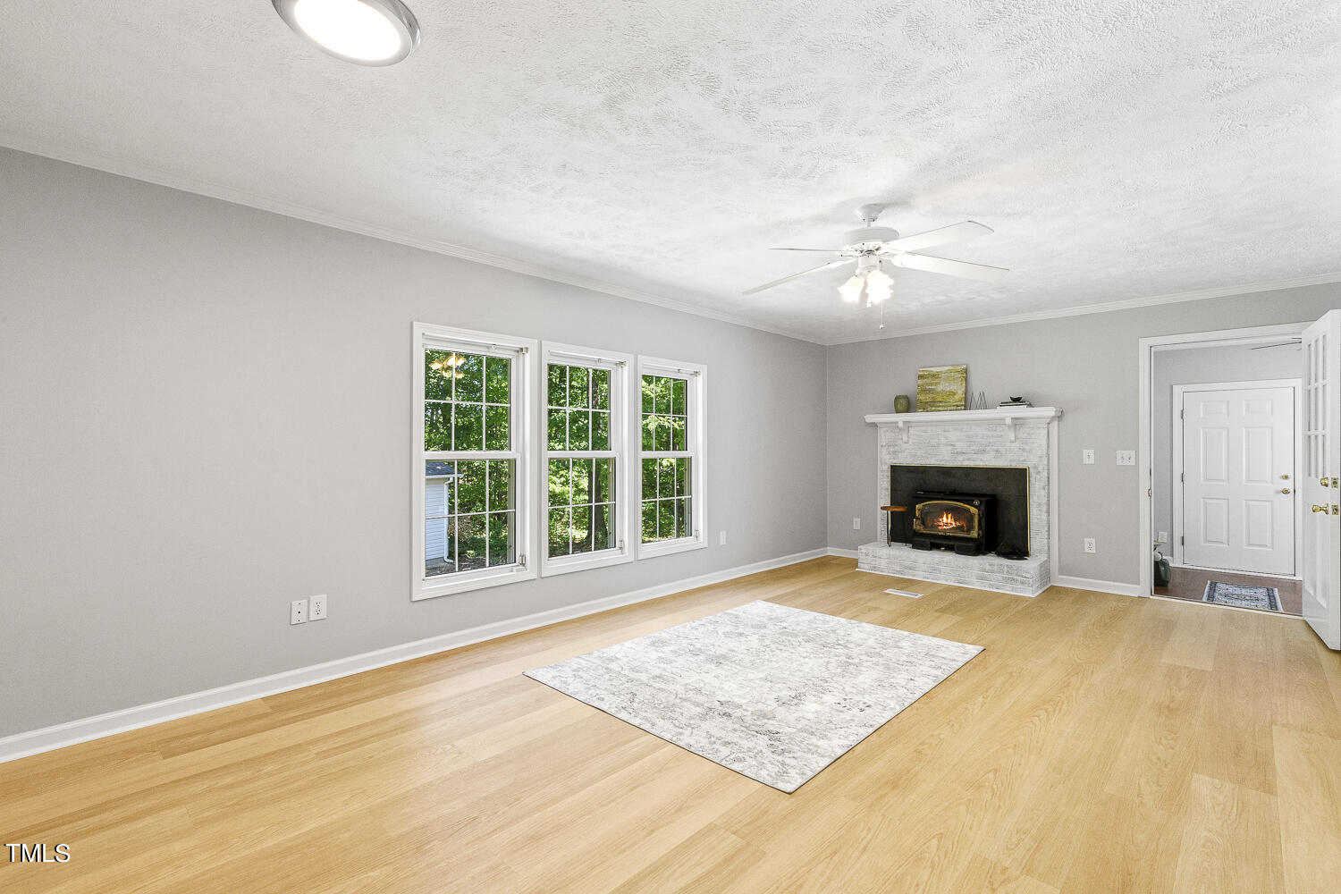 134 Rollins Mill Road Holly Springs, NC 27540 - Photo 3 of 33 a view of an empty room with a fireplace and a window