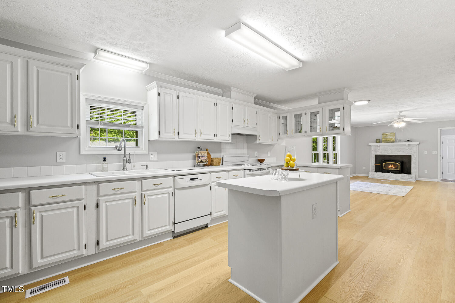 134 Rollins Mill Road Holly Springs, NC 27540 - Photo 6 of 33 a kitchen with counter top space sink and center island