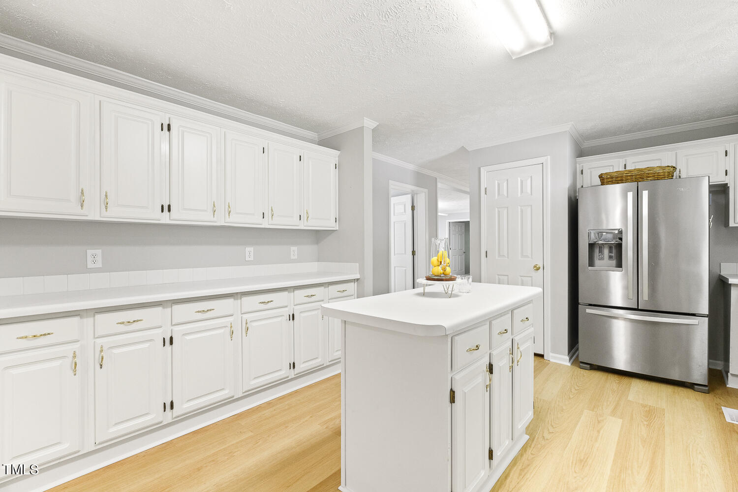 134 Rollins Mill Road Holly Springs, NC 27540 - Photo 8 of 33 a kitchen with white cabinets and refrigerator