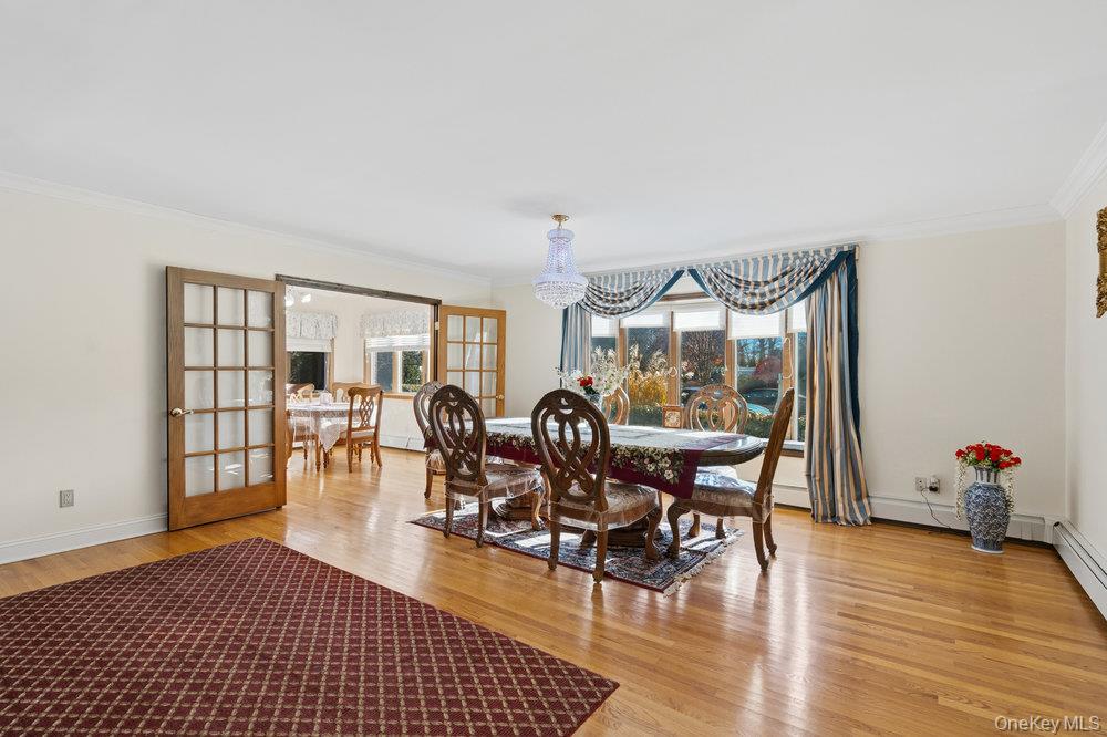 72 Lake End Road Merrick, NY 11566 - Photo 11 of 42 Dining area with french doors, ornamental molding, and light wood finished floors