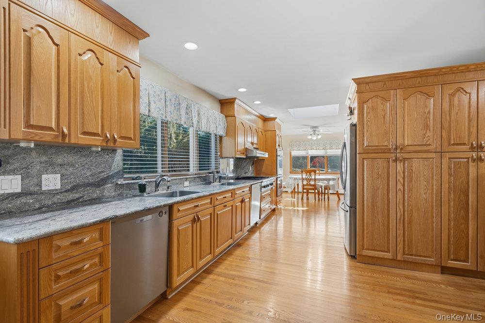 72 Lake End Road Merrick, NY 11566 - Photo 16 of 42 Kitchen with healthy amount of natural light, backsplash, light wood-style flooring, appliances with stainless steel finishes, and recessed lighting