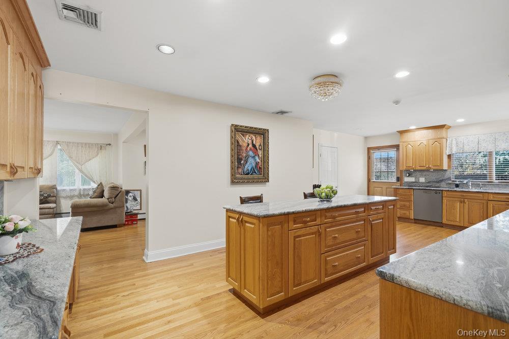 72 Lake End Road Merrick, NY 11566 - Photo 19 of 42 Kitchen with plenty of natural light, light stone countertops, light wood-style floors, a kitchen island, and recessed lighting