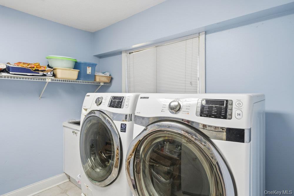 72 Lake End Road Merrick, NY 11566 - Photo 21 of 42 Laundry area featuring separate washer and dryer and baseboards