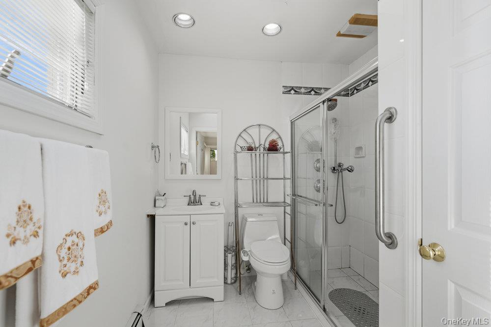72 Lake End Road Merrick, NY 11566 - Photo 27 of 42 Full bath with vanity, a shower stall, recessed lighting, and light marble finish floors