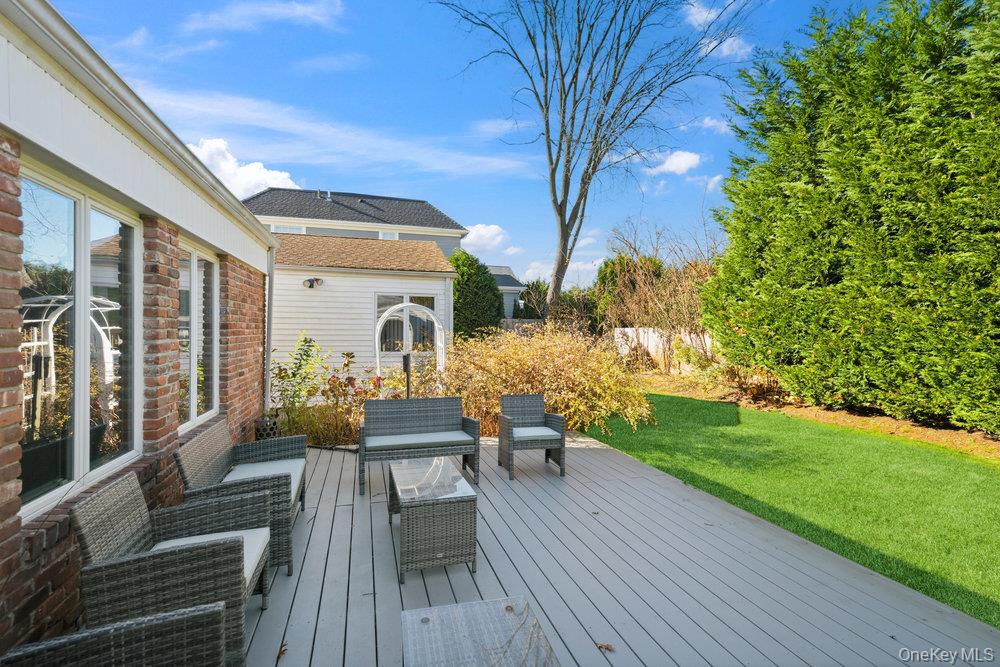 72 Lake End Road Merrick, NY 11566 - Photo 39 of 42 Wooden terrace with outdoor lounge area and a yard