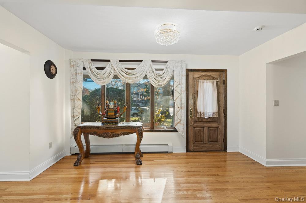 72 Lake End Road Merrick, NY 11566 - Photo 8 of 42 Foyer with light wood-type flooring and a baseboard heating unit