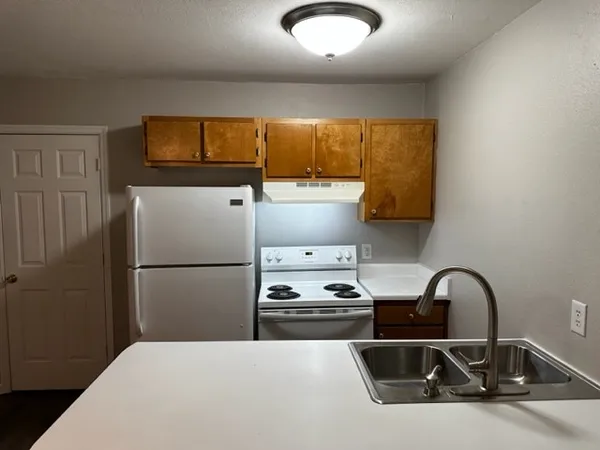 a kitchen with a refrigerator and a sink