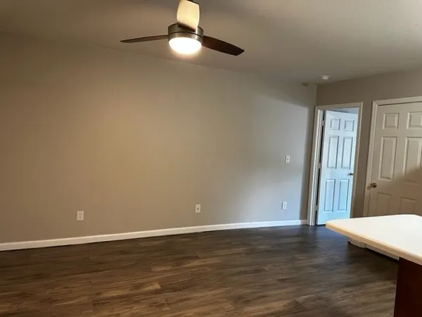 a view of a room with wooden floor and window