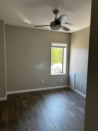 wooden floor in an empty room with a window