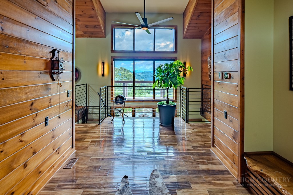 179 Adams Road Vilas, NC 28692 - Photo 7 of 50 a view of a patio with table and chairs with wooden floor