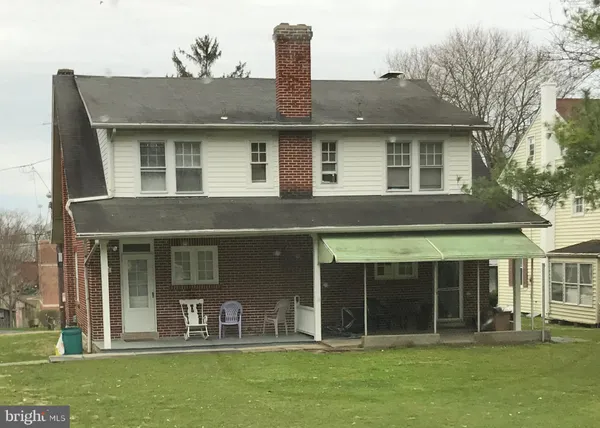 a front view of a house with a garden and plants