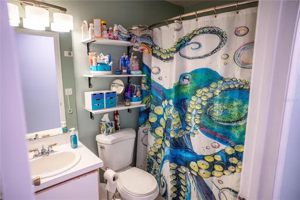 a bathroom with a sink mirror vanity and toilet