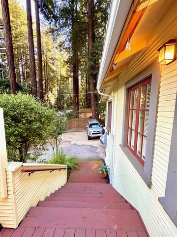 a view of a porch with wooden floor and stairs
