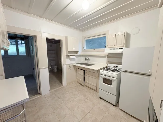 a kitchen with a stove and a refrigerator