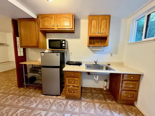 a view of a hallway with furniture and wooden floor