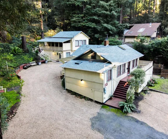 an aerial view of a house with garden space and sitting area