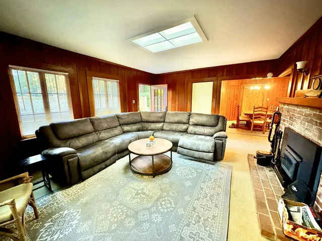 a living room with furniture fireplace and flat screen tv
