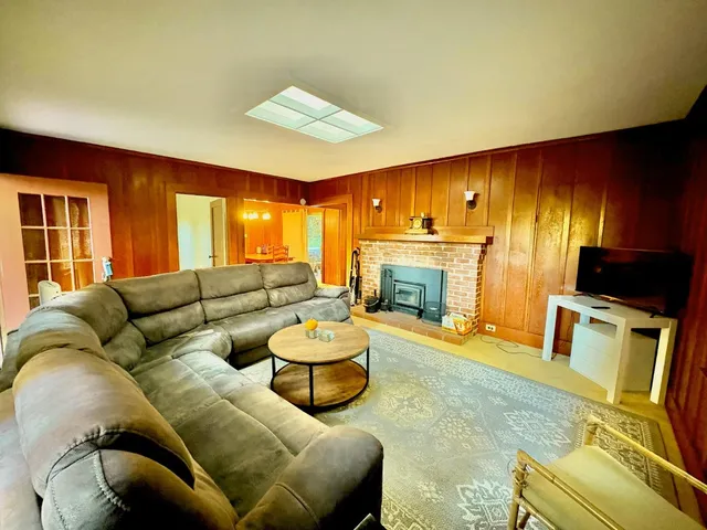 a livingroom with furniture and a flat screen tv