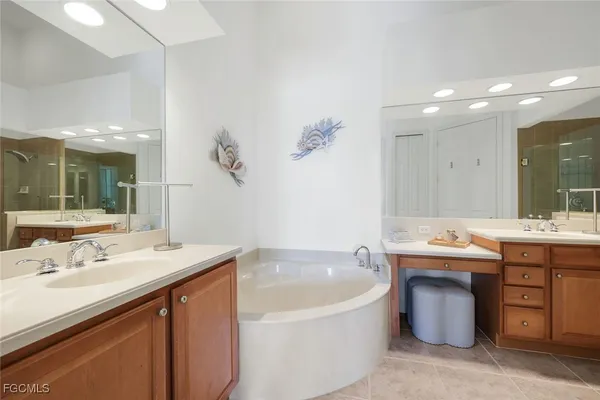 a spacious bathroom with a sink double vanity and a bathtub