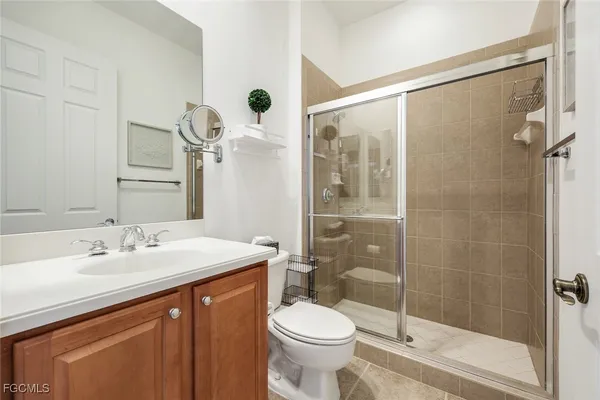 a bathroom with a sink and mirror with toilet