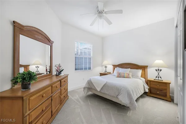 a bedroom with a bed a dresser and mirror