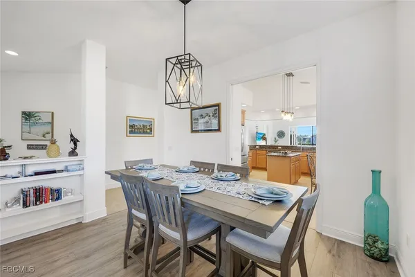 a view of a dining room with furniture wooden floor and a chandelier