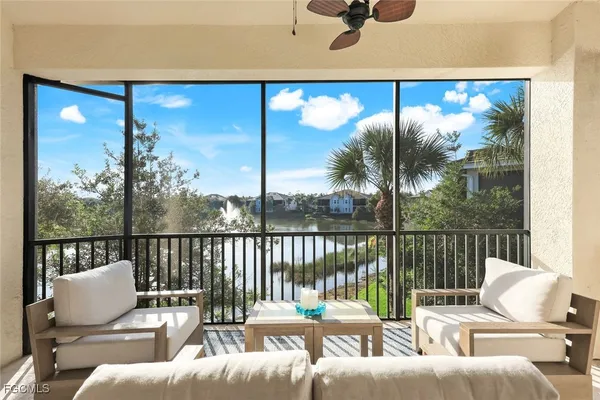 a balcony with furniture and wooden floor