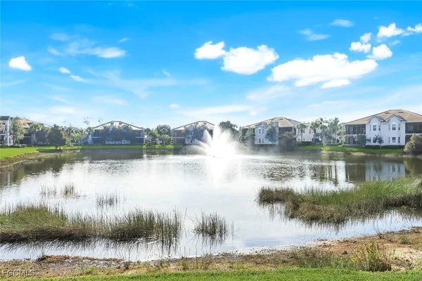 a view of a lake with houses in the back