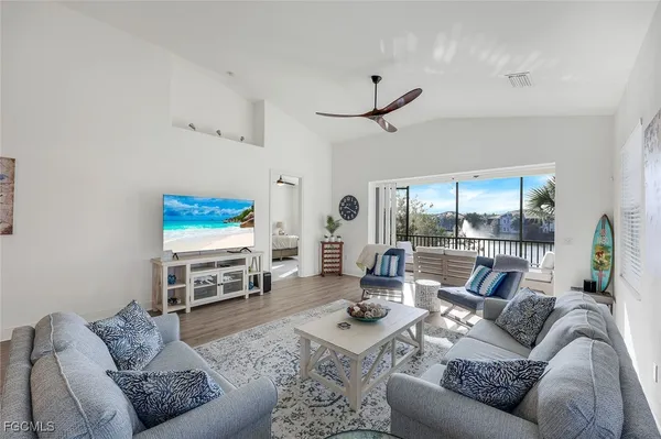 a living room with furniture a rug and a flat screen tv