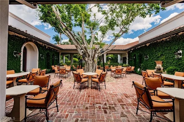 a view of patio with chairs and tables
