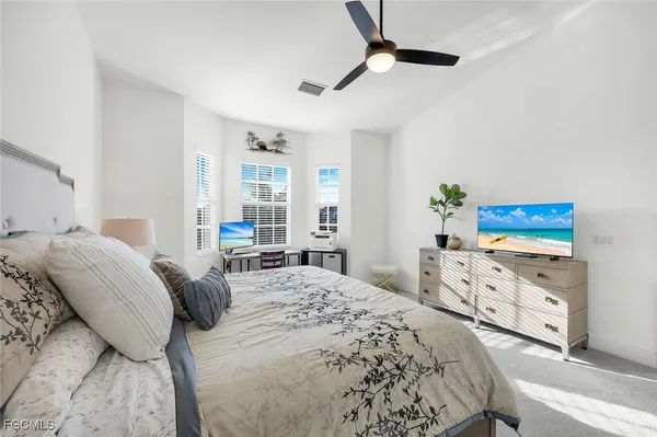 a bedroom with a bed and a dresser in it