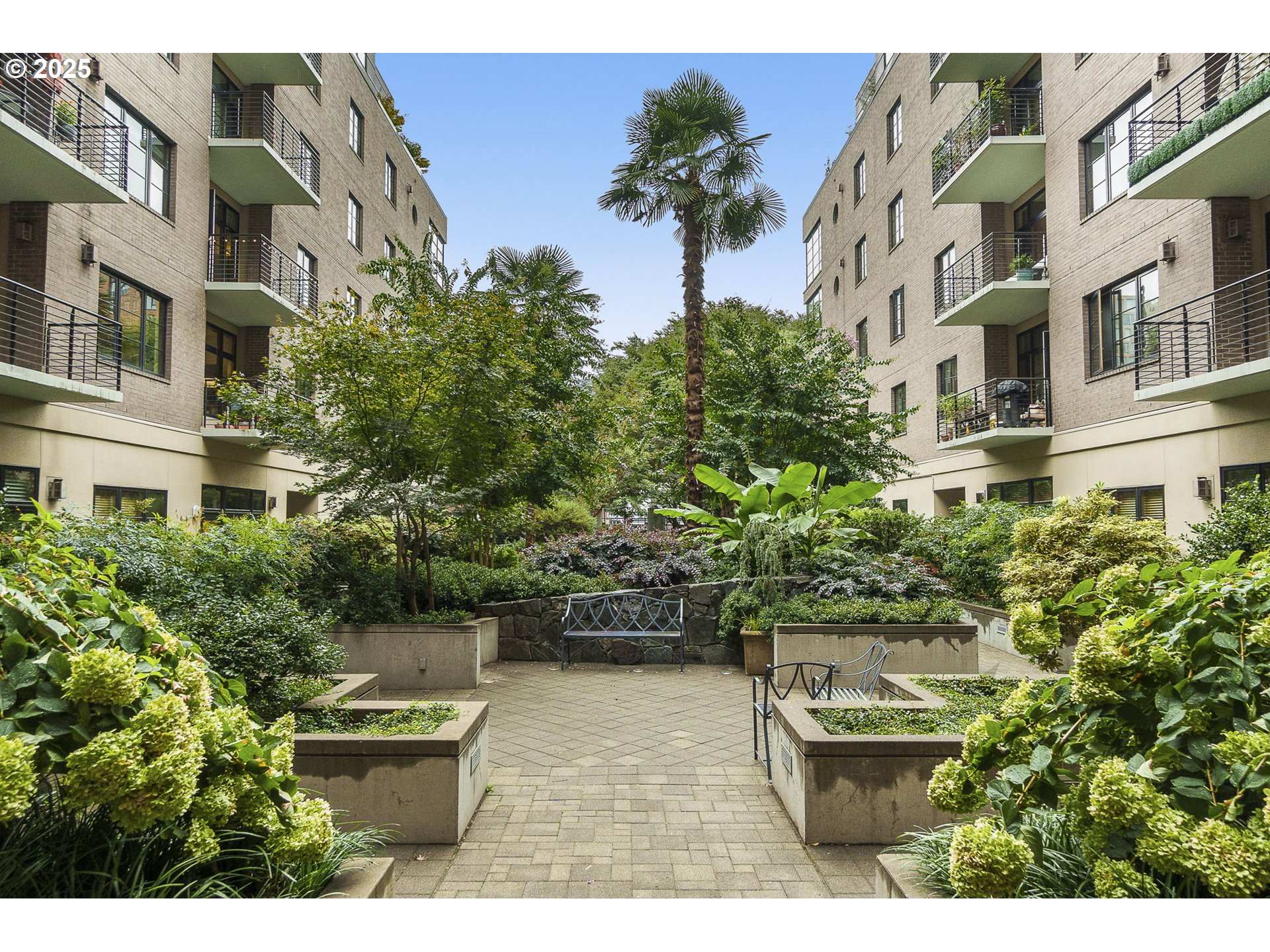 725 Northwest 10th Avenue, Unit 305 Portland, OR 97209 - Photo 22 of 35 a view of building with potted plants and bench
