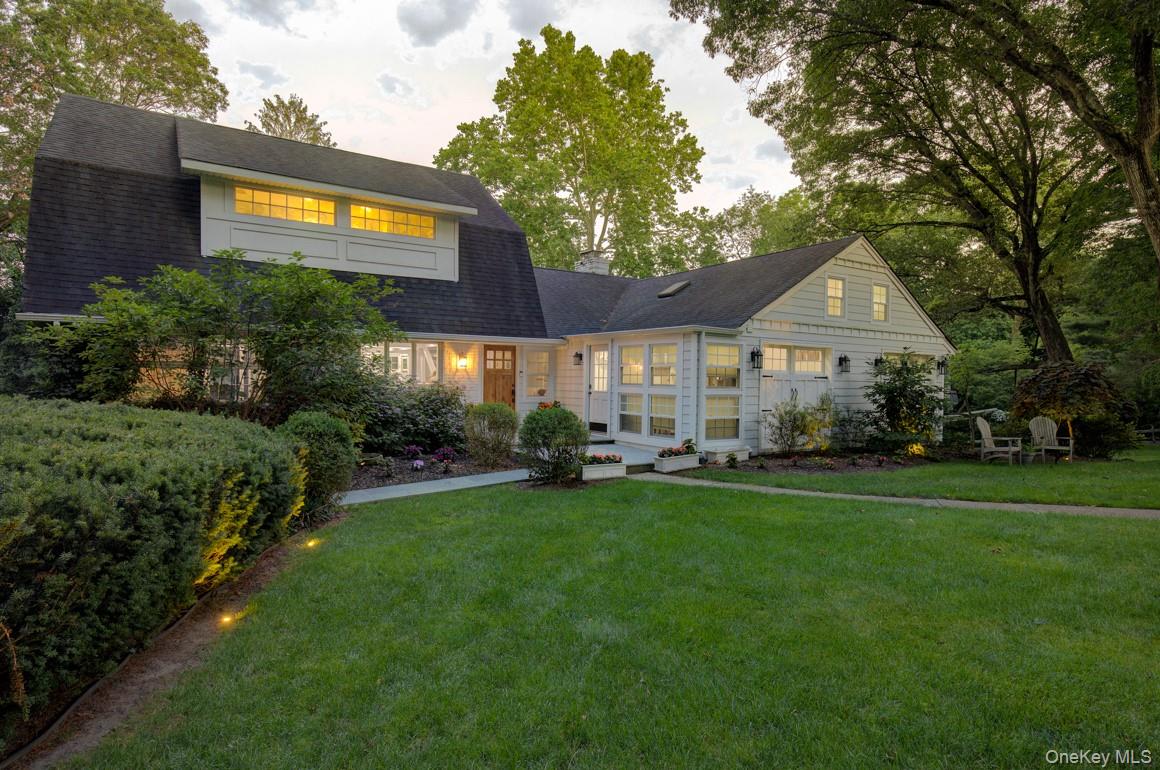 2 Spring Hollow Road Centerport, NY 11721 - Photo 43 of 49 a front view of a house with a garden