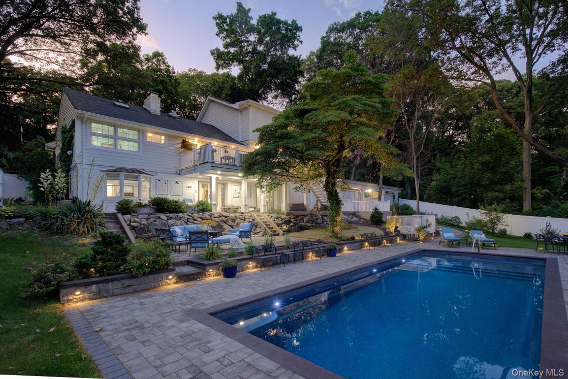 2 Spring Hollow Road Centerport, NY 11721 - Photo 46 of 49 Pool at dusk featuring a patio and a fenced backyard