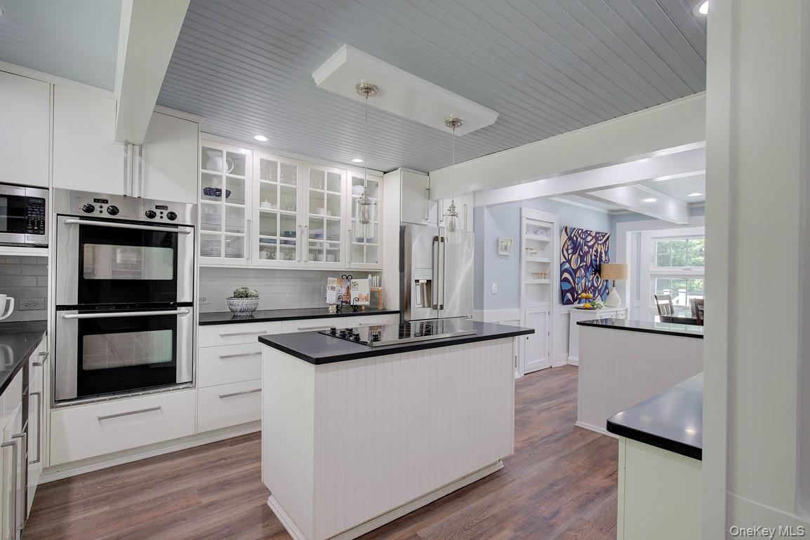 2 Spring Hollow Road Centerport, NY 11721 - Photo 9 of 49 Kitchen featuring stainless steel appliances, dark countertops, a kitchen island, white cabinets, and wood ceiling