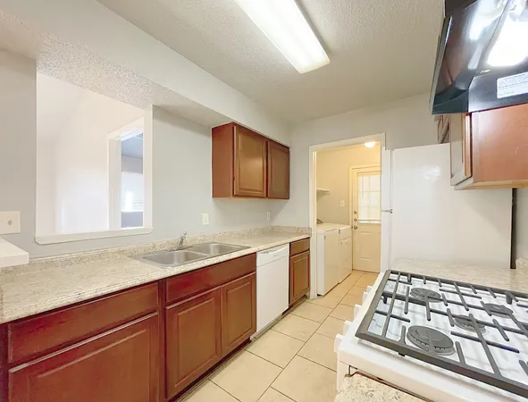 a kitchen with a sink and a stove top oven