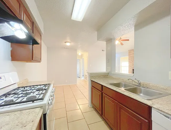 a kitchen with a sink stove and cabinets