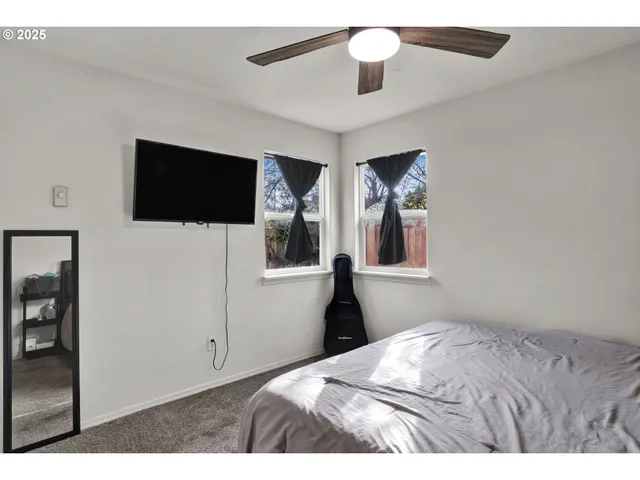 a bedroom with a bed and a flat screen tv
