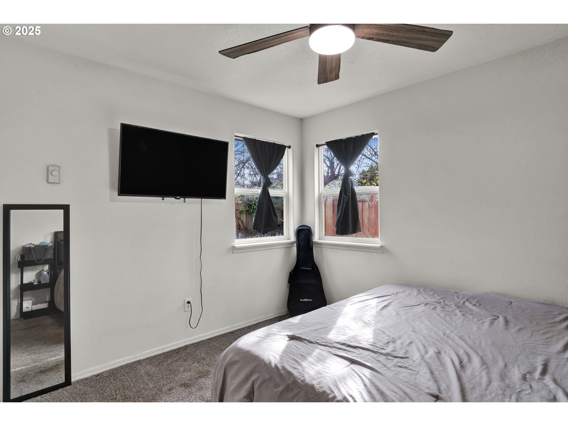 422 Elder Street Drain, OR 97435 - Photo 18 of 41 a bedroom with a bed and a flat screen tv