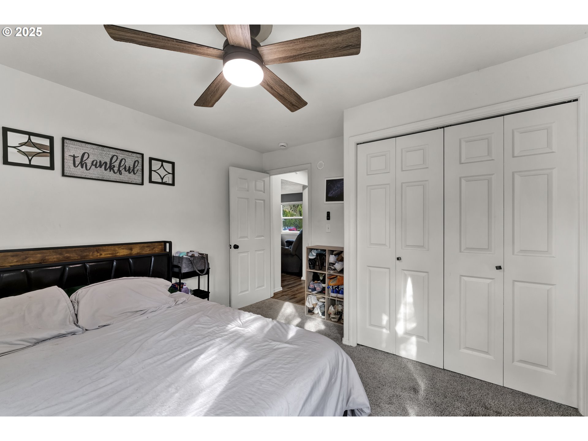 422 Elder Street Drain, OR 97435 - Photo 19 of 41 a bedroom with a bed and a chandelier