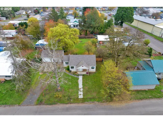 an aerial view of residential houses with outdoor space and street view
