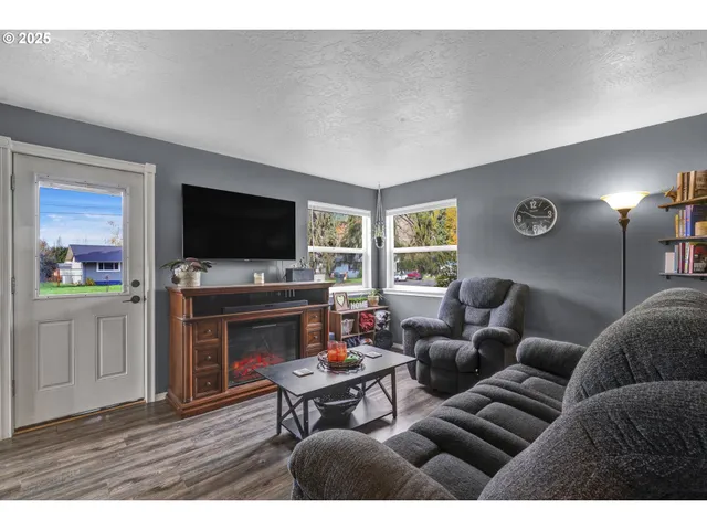 a living room with furniture and a flat screen tv