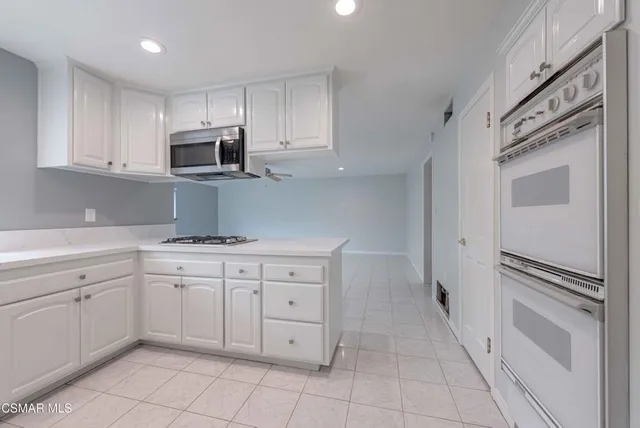 a kitchen with granite countertop cabinets and steel stainless steel appliances
