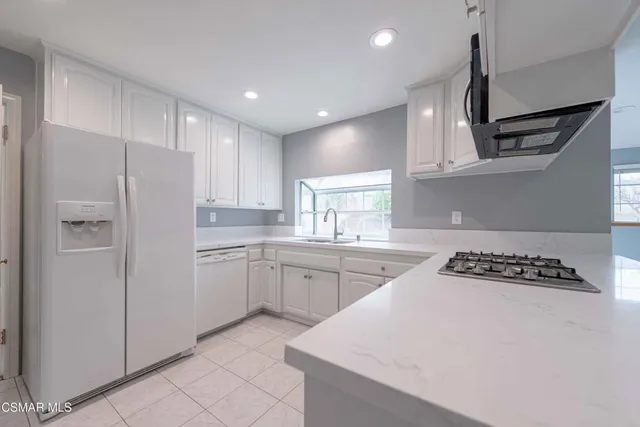 a kitchen with cabinets and window
