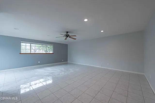 a view of an empty room and a window