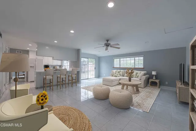an empty room with windows and cabinet