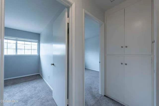 a bedroom with a bed and a potted plant